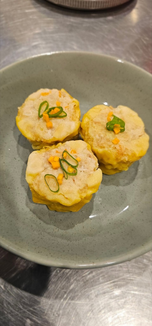 Three steamed pork dimmies on a plate